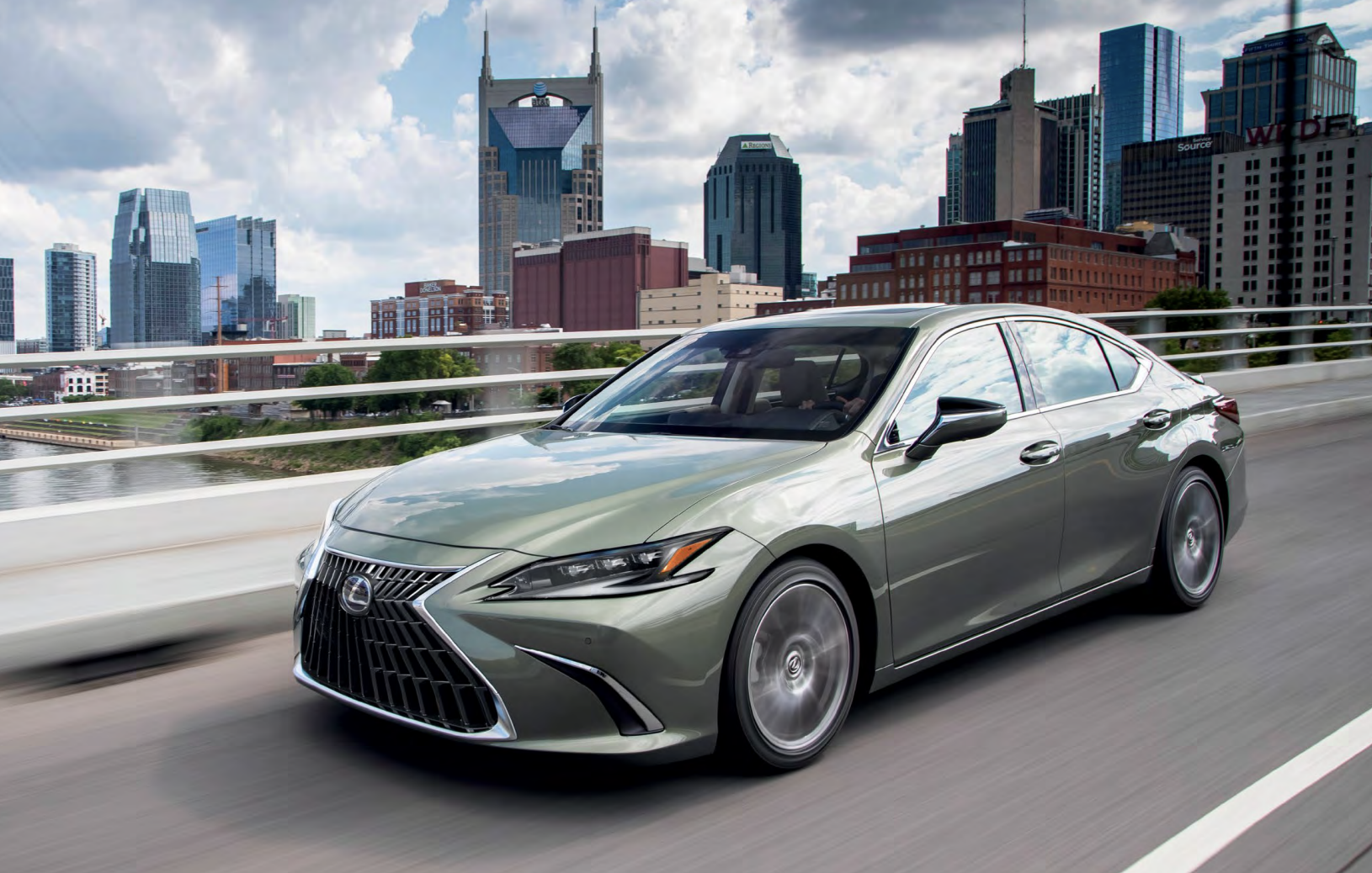 pre-owned 2024 Lexus ES driving through along the city